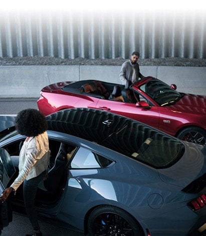 Two people exiting their parked 2024 Ford Mustang® coupe and convertible | Joe Hall Ford in Lewiston ID