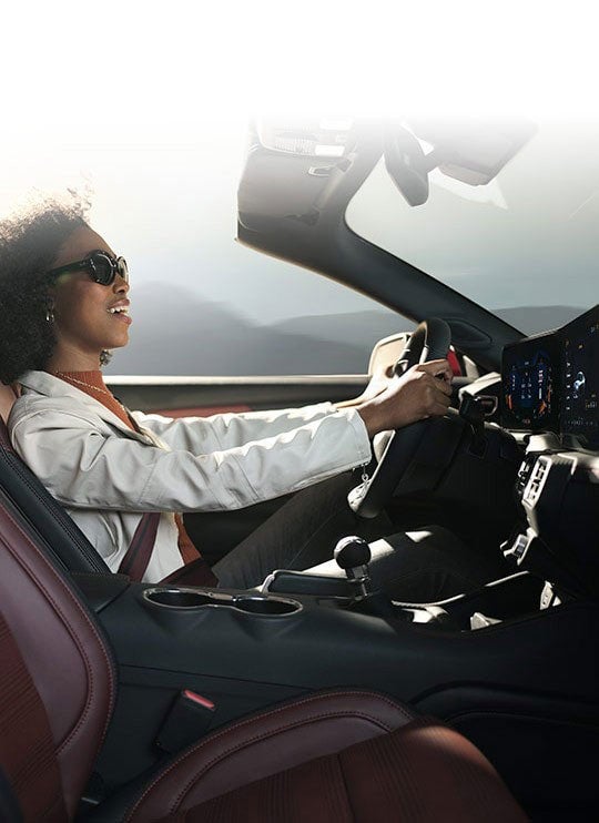 Person sitting in the driver’s seat of a 2024 Ford Mustang® convertible | Joe Hall Ford in Lewiston ID